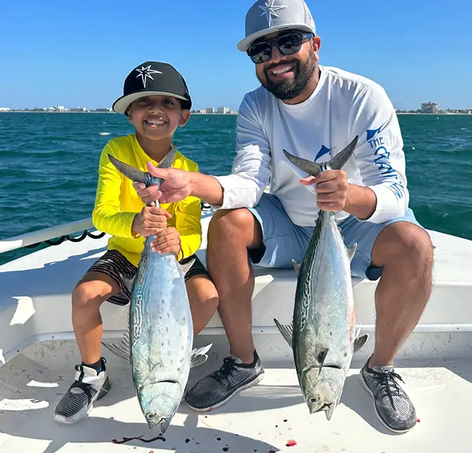 Man and son with two bonita on St. Pete fishing charter